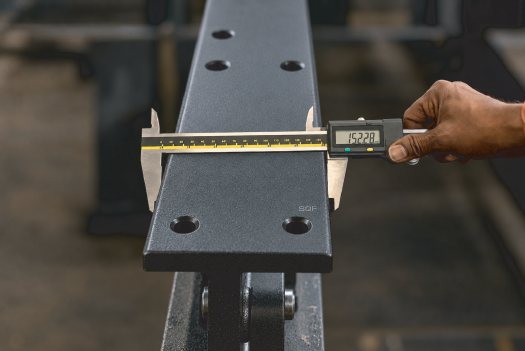 Technician inspecting a steel tube